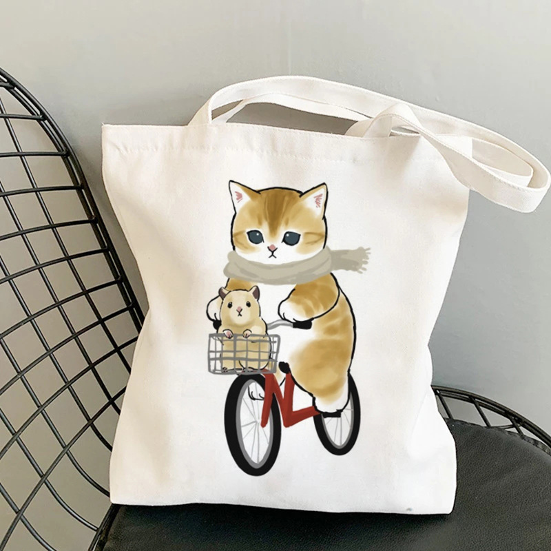 Comercio exterior gato montar bicicleta lindo impreso bolsa de lona bolso de hombro estudiante bolso de compras