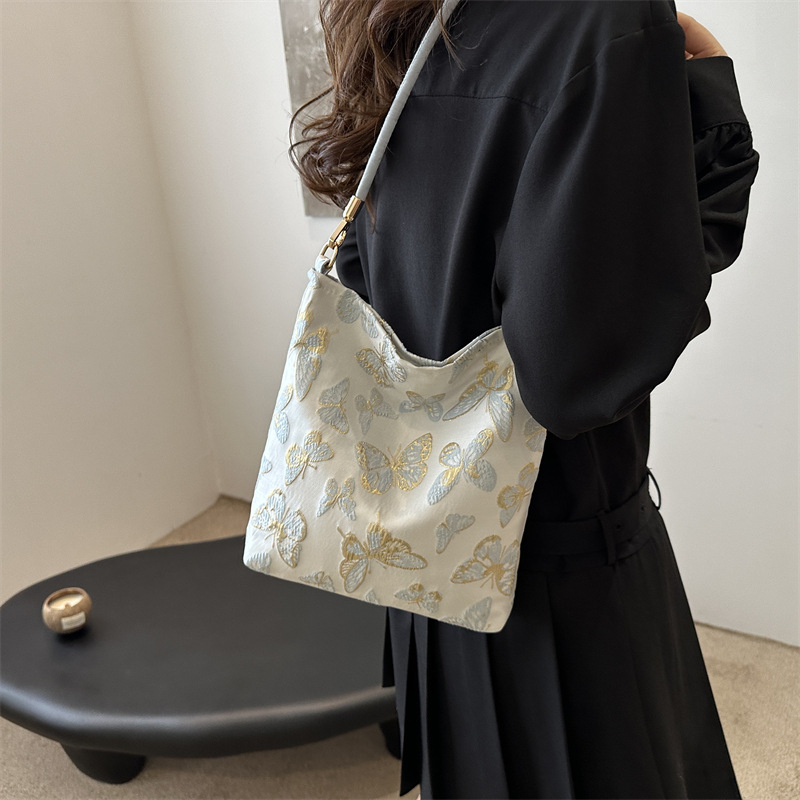 New Guofeng Jacquard canvas bolsas para mujeres 2024 verano nuevo popular bolso de hombro universal para viajar bolsas de cubo debajo de las axilas