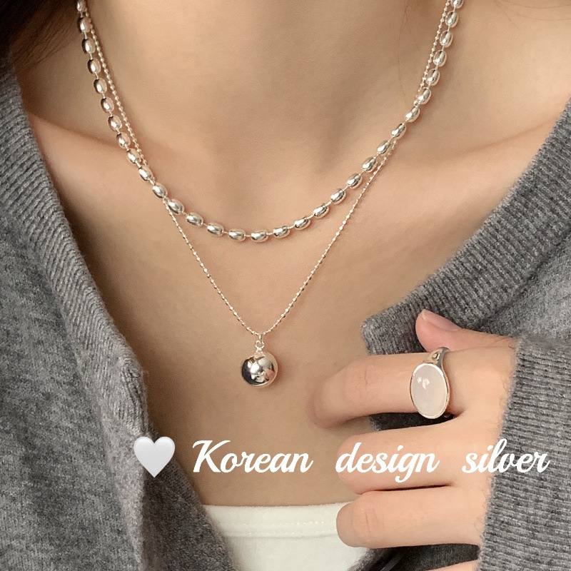 Koreyscha dizayndagi, og'ir S925 sterling kumushdan yasalgan ikki qavatli dumaloq zaytun rangli marjon, nafis ko'rinish uchun qatlamlangan, sviterlar uchun juda mos keladi.