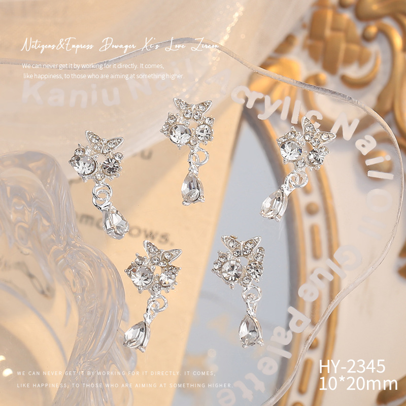 Nueva joyería de aleación de manicura completa diamante borla arco corona plata uñas manicura joyería accesorios al por mayor