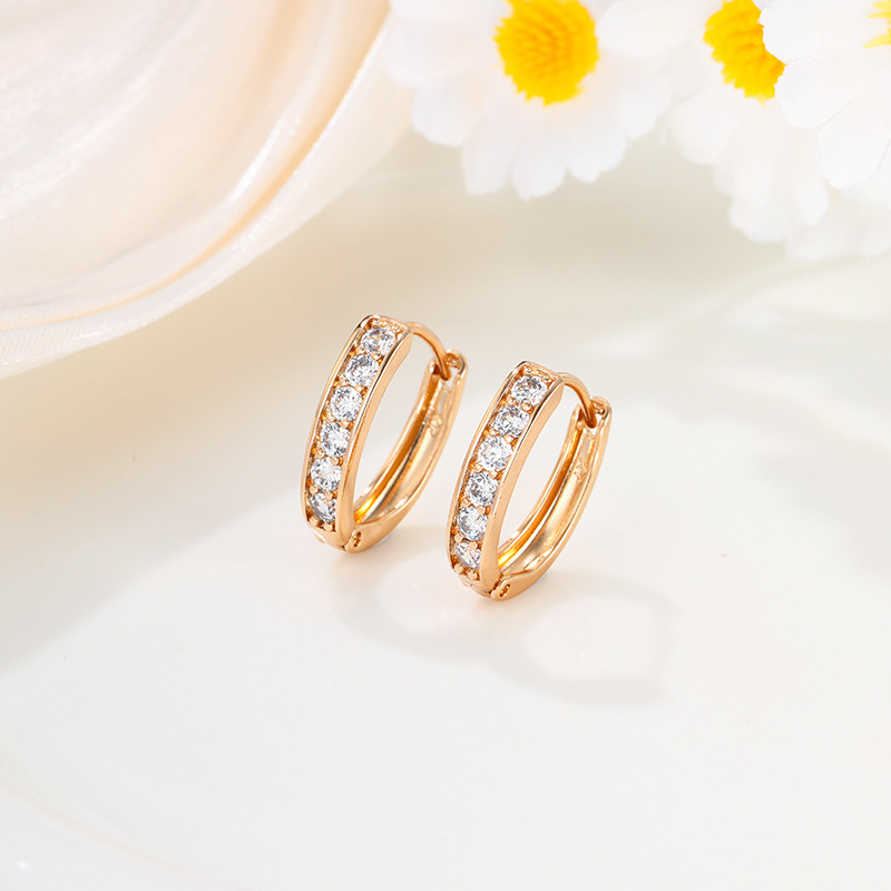 Xuping Europa y los Estados Unidos transfronterizos aleación de cobre chapado 24k aretes de color pernos de orejas incrustados en una sola fila de joyas artificiales orejas al por mayor mujeres