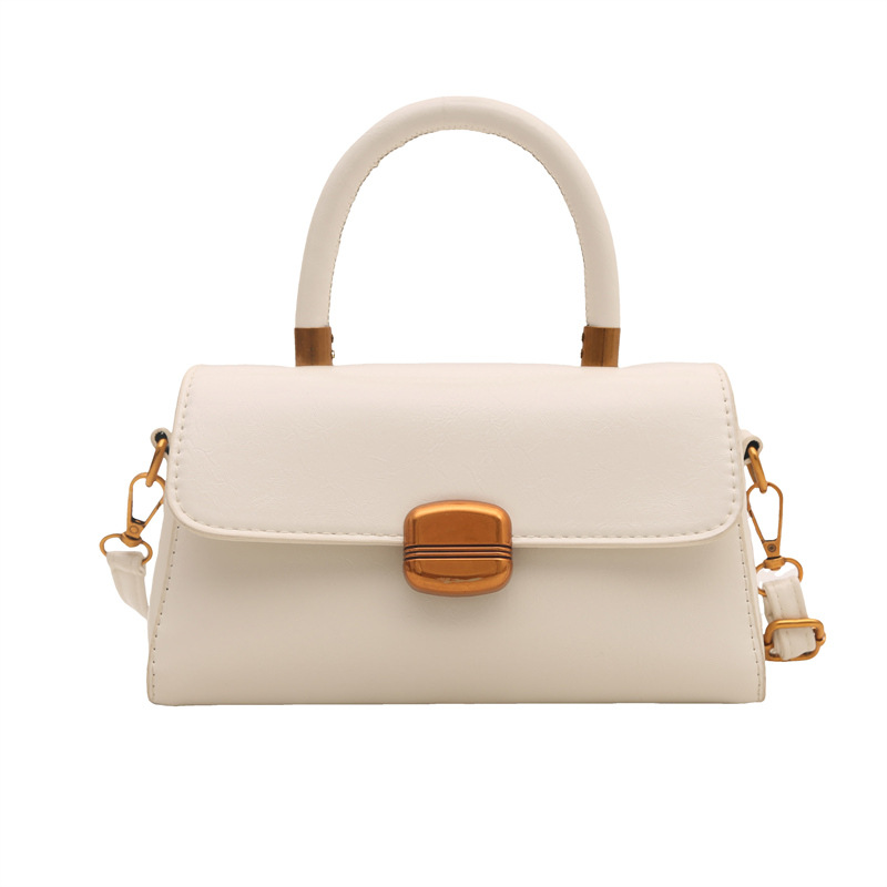 Nicho de diseño coreano bolso de mano 2025 primavera nuevo estilo simple de moda con cierre de flip de hombro monocolor bolso de mochila
