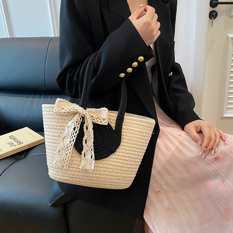 Bolsa de moda de color contrastante portátil de tejido de mujer 2025 tendencia primavera nuevo retro versátil arco bolso de cubo de mano