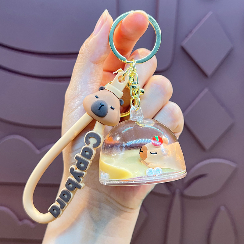 Botella creativa de aceite flotante Capibara Dolphin Keychain bolsos de automóviles exquisitos colgantes de arena flotante regalos al por mayor