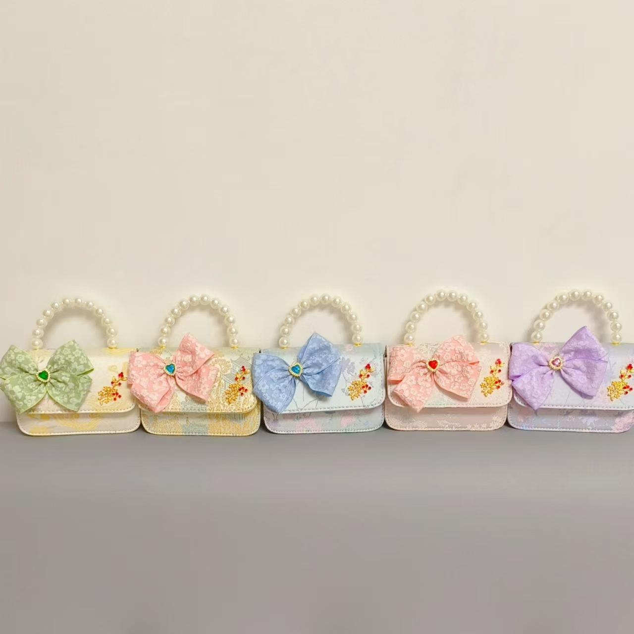 Bolso infantil nuevo bolso de hombro de niñas lindos bolsos de perlas de princesa arco de mariposa estilo nacional bolso de mochila pequeña bolsa