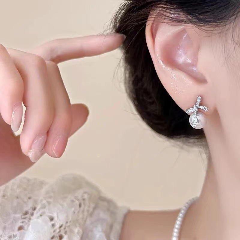 Elegant fashionable earrings with zircon with bow pearl
