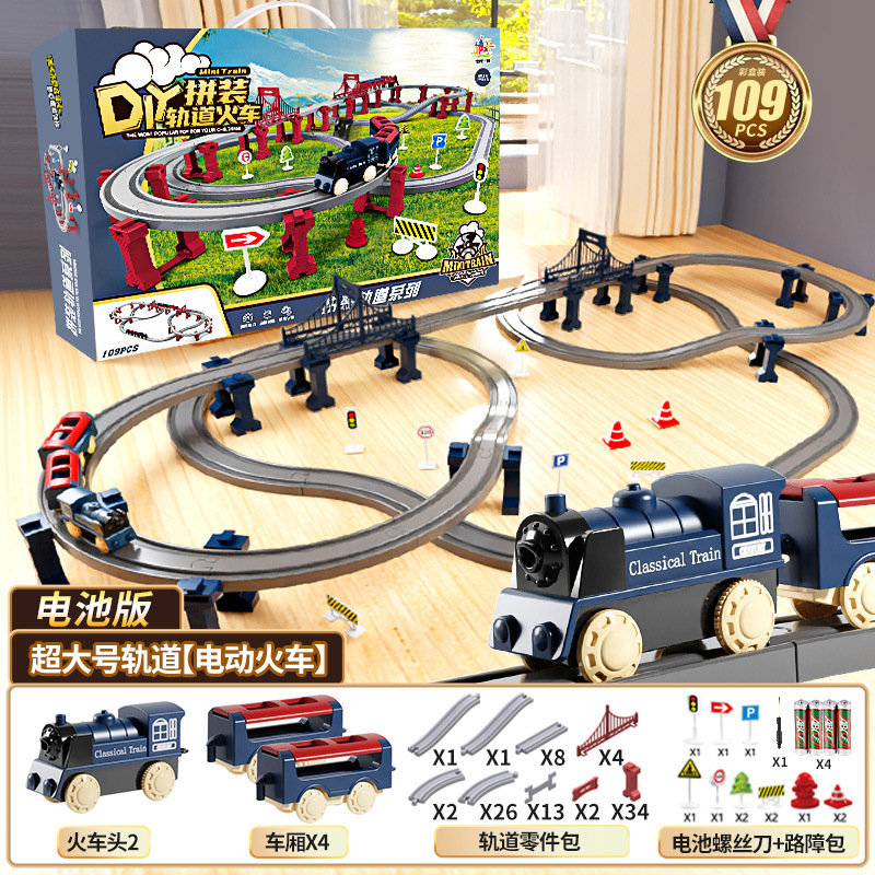 国境を越えた電気高速鉄道の電車は軌道を持っている男の女の子が模型を組んで車のおもちゃの誕生日プレゼントをシミュレートした