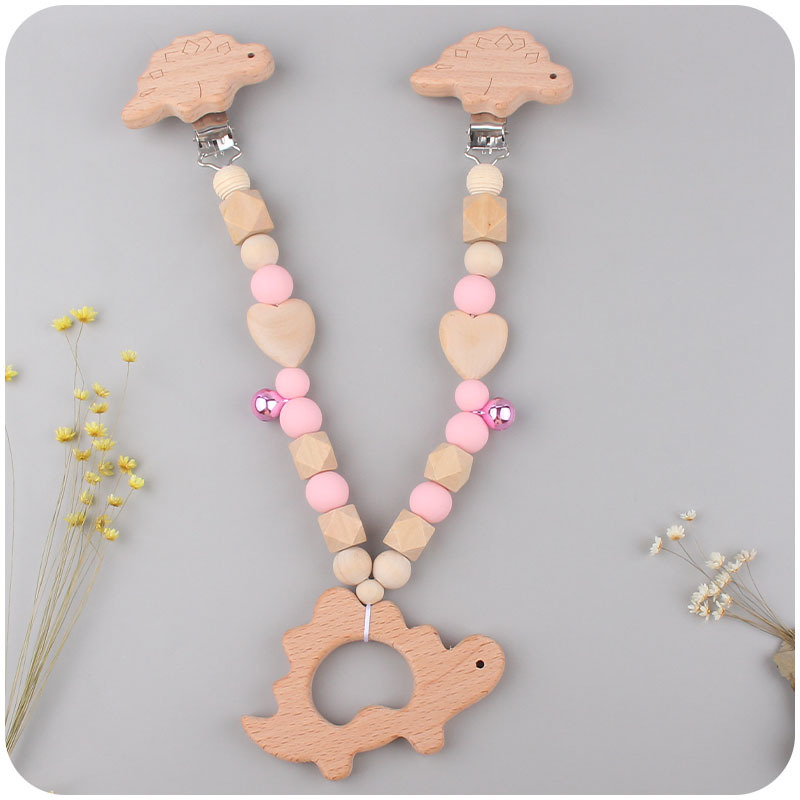 Suministros para bebés pulsera de silicona molar de juguete para niños Cadena de cochecito de dinosaurio de tres piezas creativa pequeña campana colgante