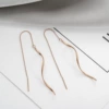 Wavy golden earrings, pink gold