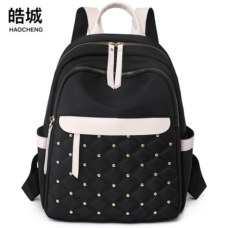 Bolsos para mujer 2023 nueva mochila de nailon para mujer coreana moda contraste color remache mochila de viaje mochila escolar en nombre del cabello