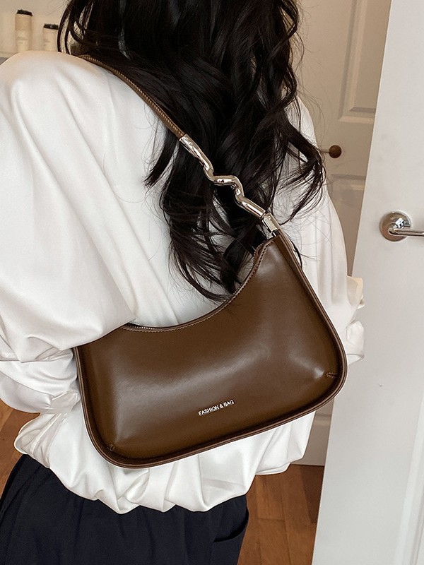 Nicho de diseño bolso de brazo para mujeres 2026 comercio exterior nueva moda alta sensación de viaje simple bolso de media luna de hombro
