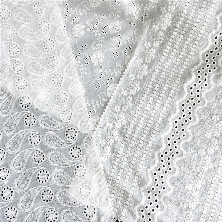 厂家供应棉巴厘纱绣花梭织布多花型面料镂空洞洞花交织混纺花边布
