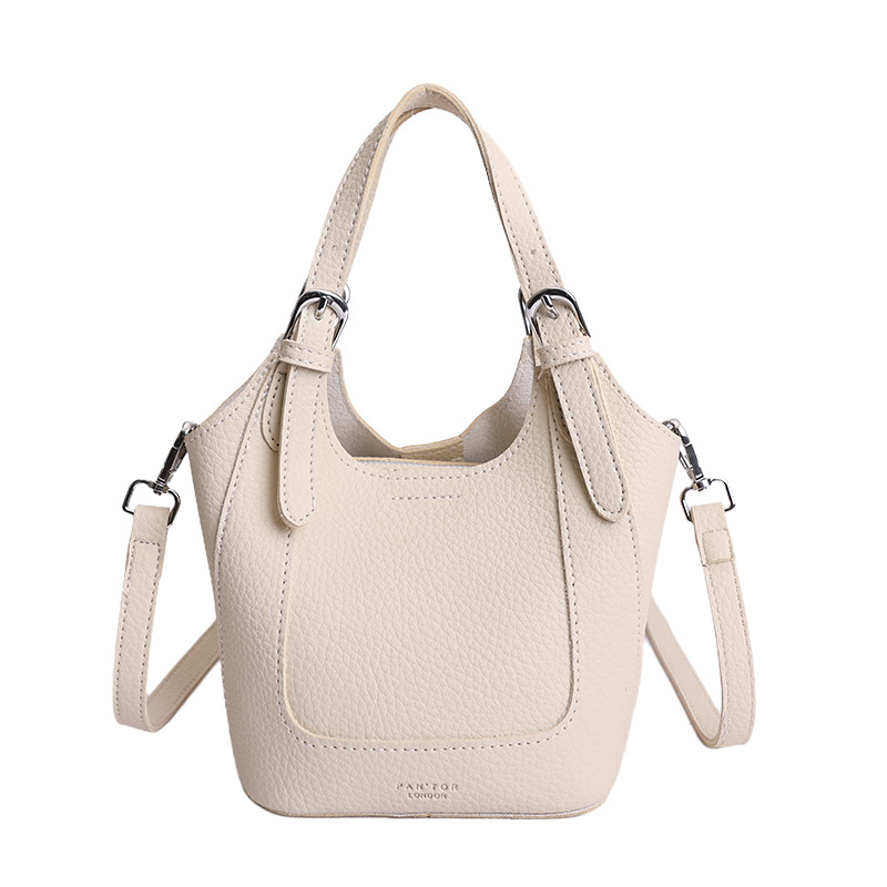 2026 nueva moda versátil cesta de verduras portátil bolso de cubo de agua de alta calidad litchi patrón ligero bolso de lujo bolso de mochila