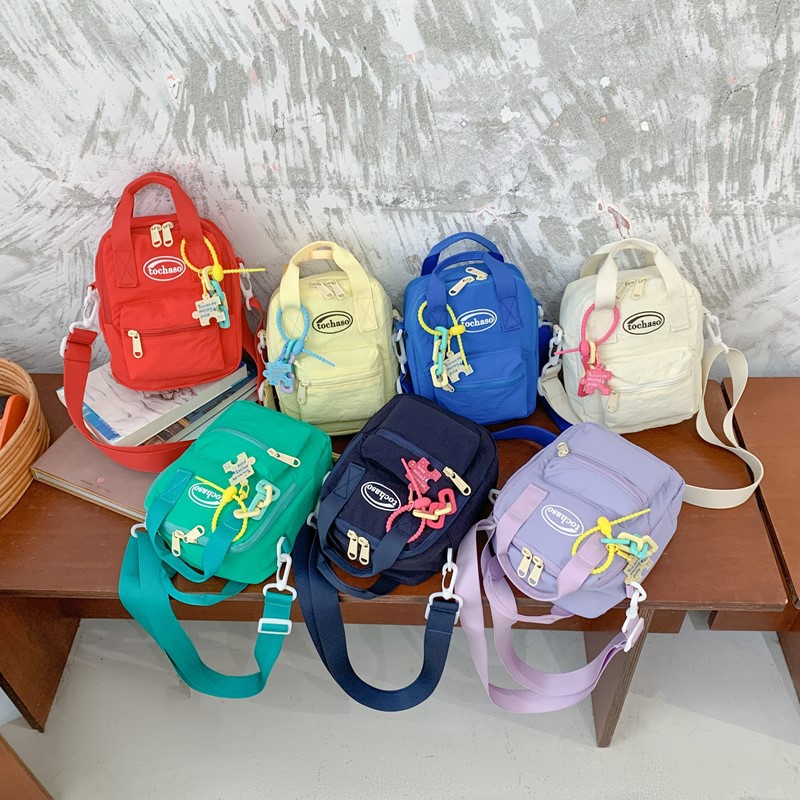 Nuevo comercio exterior bolso para niños, mini bolso simple de color sólido para bebés, bolso de cambio para viajes al aire libre para hombres y mujeres