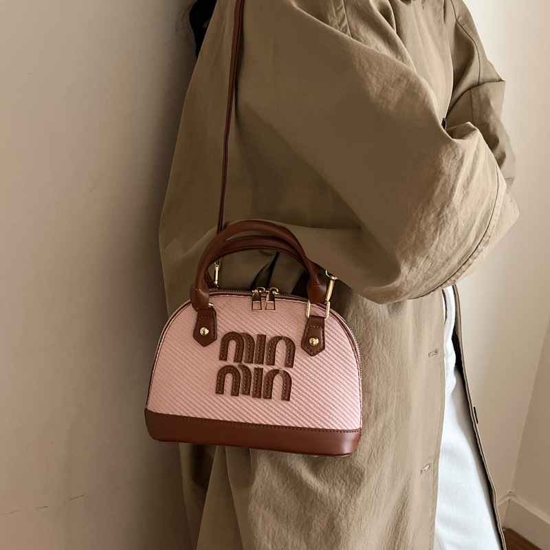 Tendencia transfronteriza coreana bolso de mano conchas bolso de mujer 2026 primavera nuevo empalme color bolso de hombro bolso de viaje