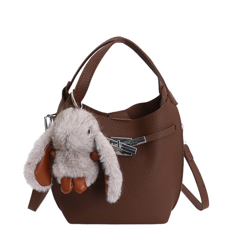 Bolso de mujer nuevo estilo coreano nicho de moda lichi bolso de cubo portátil de alta sensación de ocio mochila de viaje