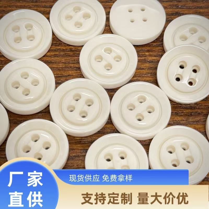 White Thickened Four-Hole Resin Buttons with a Glossy Finish for Winter Woolen Coats, Suit Buttons, Sweater Buttons, and Trench Coat Buttons White Thickened Four-Hole Resin Buttons with a Glossy Finish for Winter Woolen Coats, Suit Buttons, Sweater Buttons, and Trench Coat Buttons