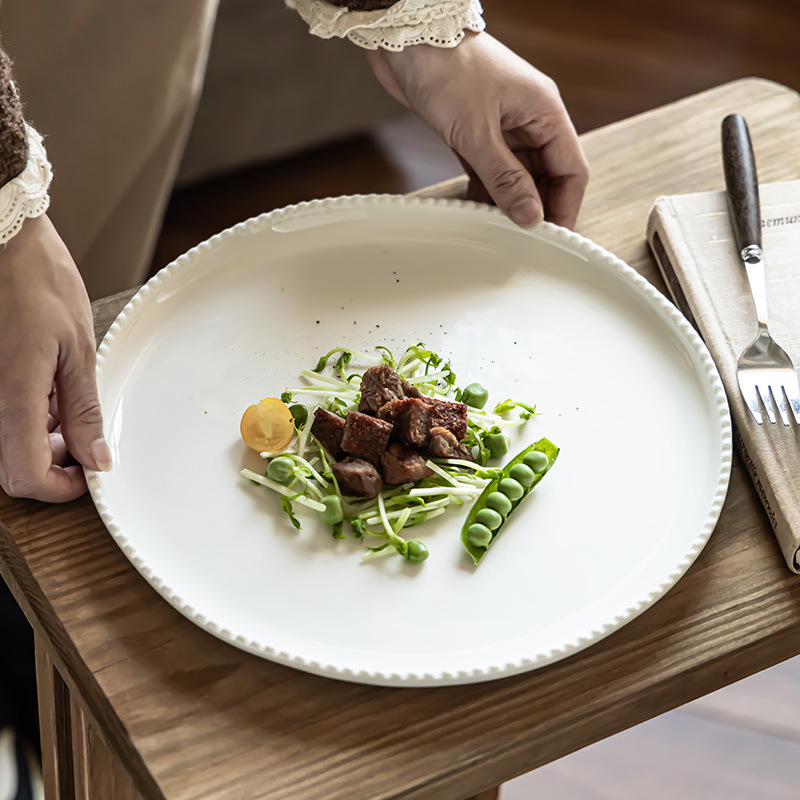 Platos de cerámica de color sólido al por mayor platos de mesa de alta calidad platos redondos de cuentas platos caseros platos de filete de comida occidental