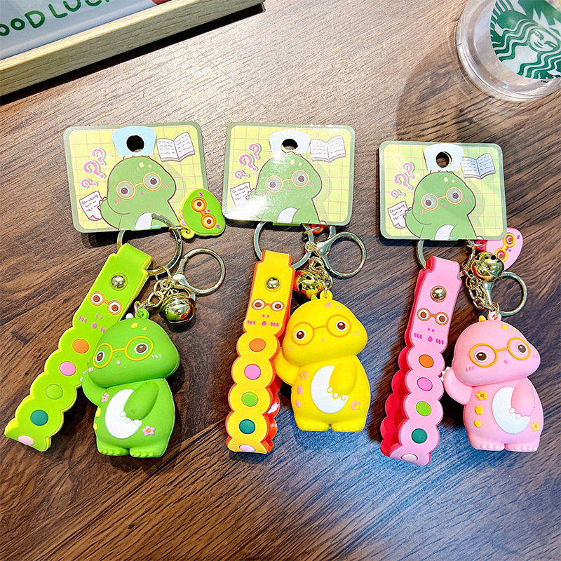 Keychain dinosaurio auténtico lindo bolso colgante de goma blanda llavero de automóvil muñeca pequeña máquina de regalos al por mayor image 3