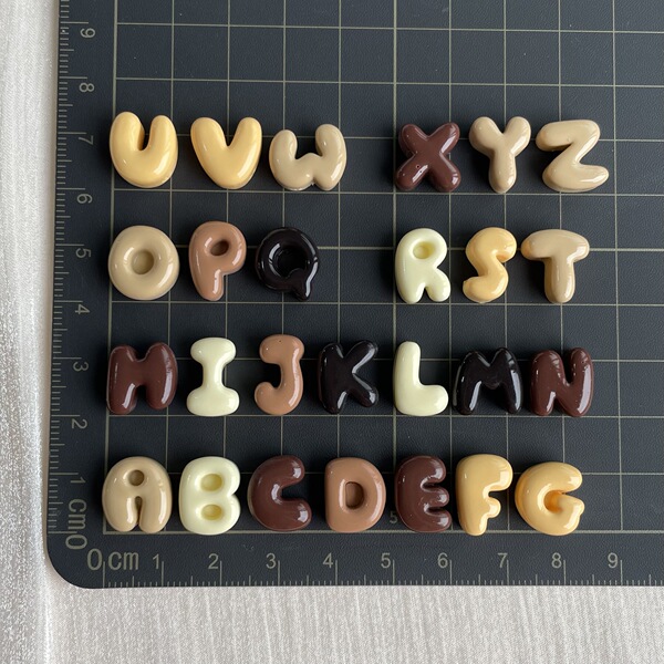 small brown accessories with letters