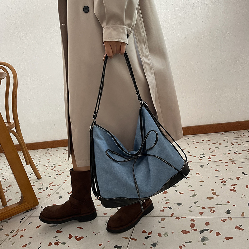 Bolsa de lona de nicho coreana para mujeres 2024 nueva moda de transporte de doble uso mochila de hombro universal