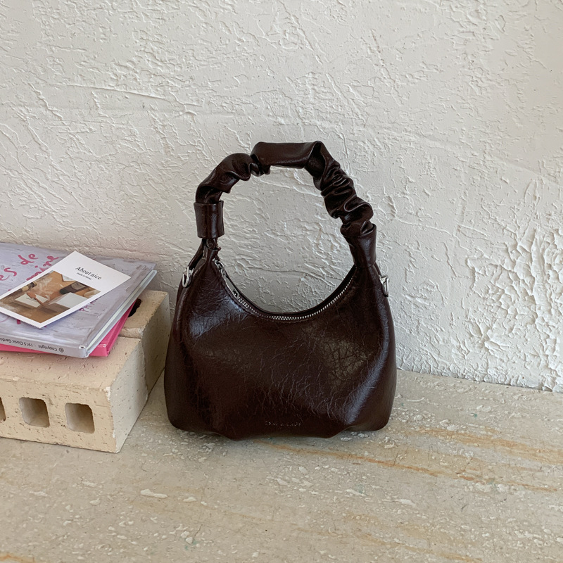 2026 primavera nueva moda temperamento bolso de hombro de moda bolso de arco de moda moda bolso de mano de tendencia diaria plegado mochila