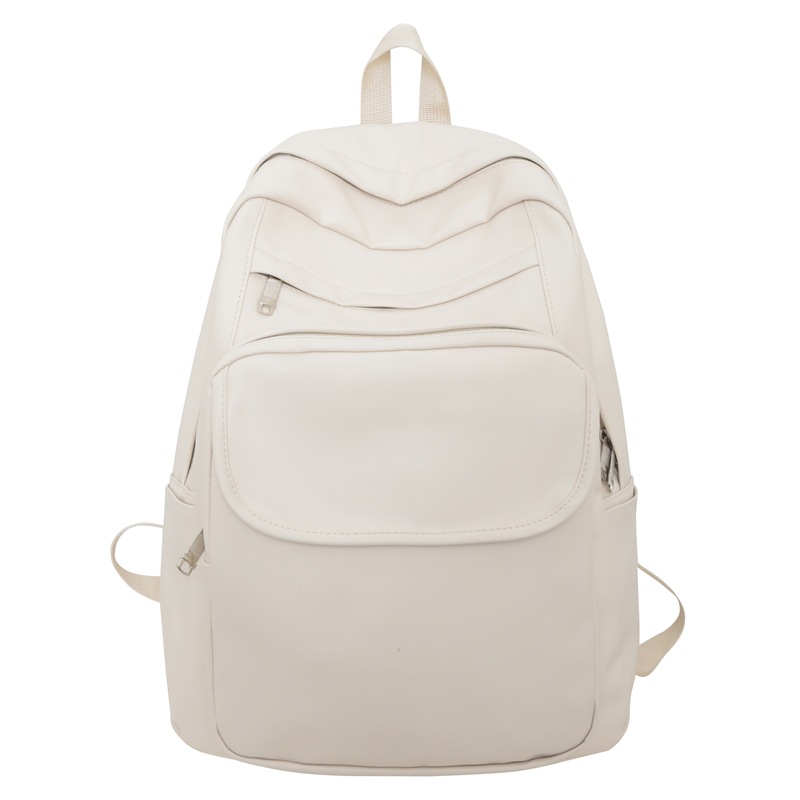 Comercio exterior al por mayor 2023 nueva versión coreana de la mochila de cuero suave para estudiantes de secundaria Mochila de computadora de gran capacidad de color sólido de moda