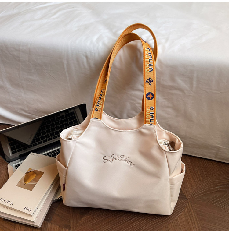 Bolsas de lona de moda de gran capacidad para mujeres 2026 nueva textura bordada letras bolsas de hombro de viaje simple bolsas de mano