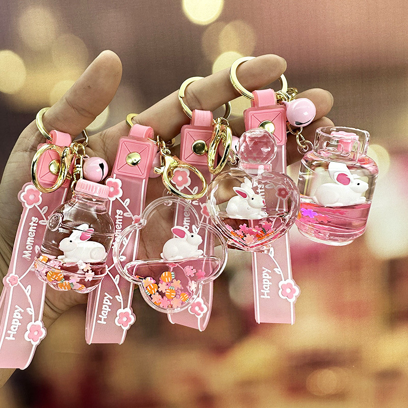 Colgante de llavero de conejo de botella de arena rosa, muñeca flotante creativa, decoración de mochila para niña, regalo exquisito para pareja