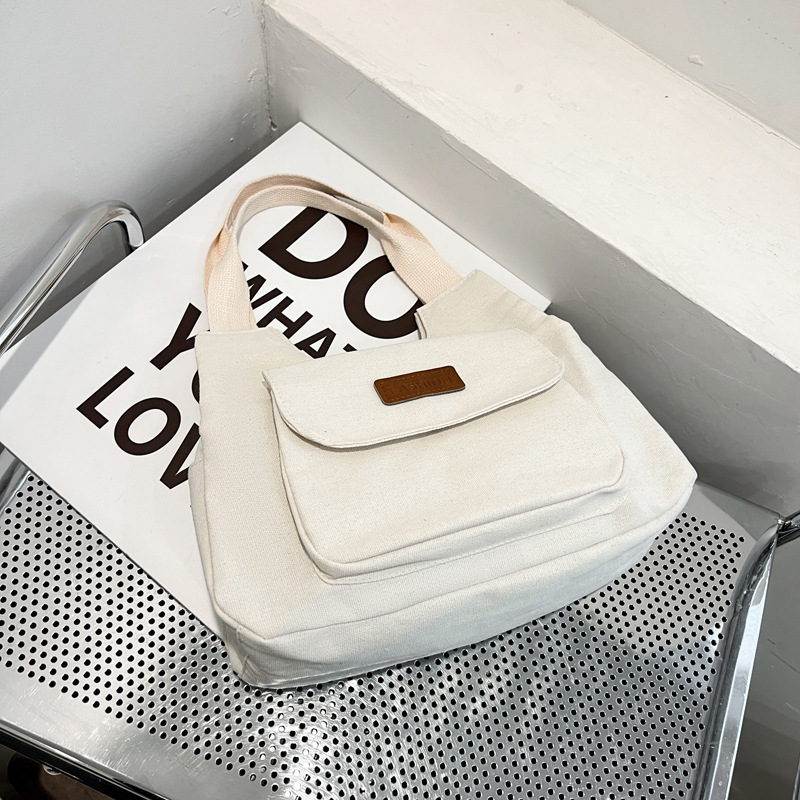 2024 invierno nuevo paquete de viaje japonés retro nicho sensación de diseño bolso de lona simple color sólido bolso casual