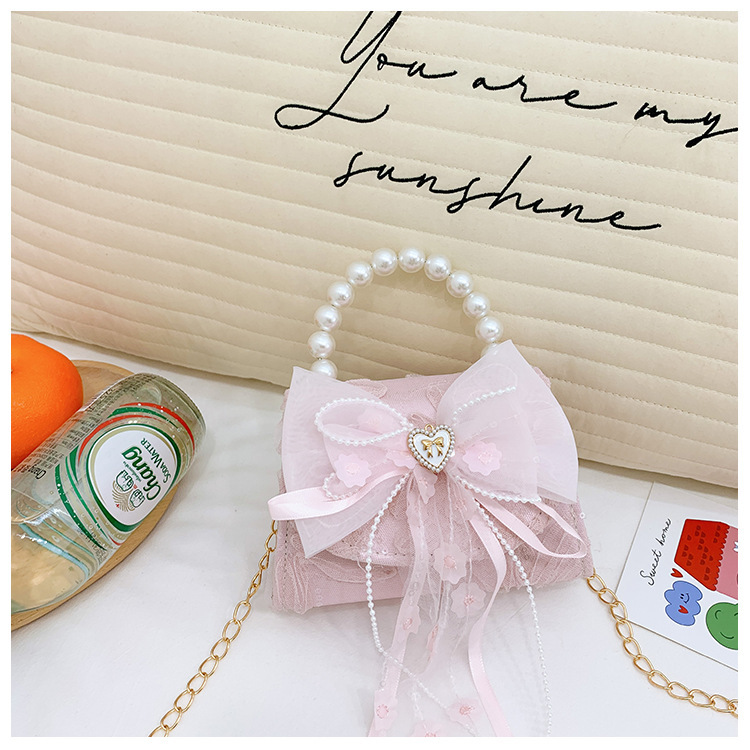 Nuevo bolso de moda para niños bolso de perla animado lindo arco de botón bolso de hombro de niñas cadena diagonal bolso pequeño