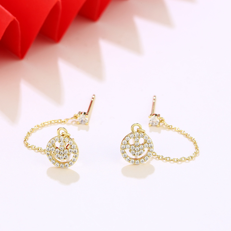 Joyas Xuping personalidad europea y americana sonriente pernos de orejas de aleación nicho ligero lujoso frío orejas de viento para mujeres exquisitas verano