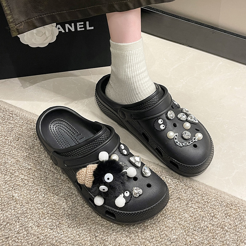 Black Crocs-style slippers