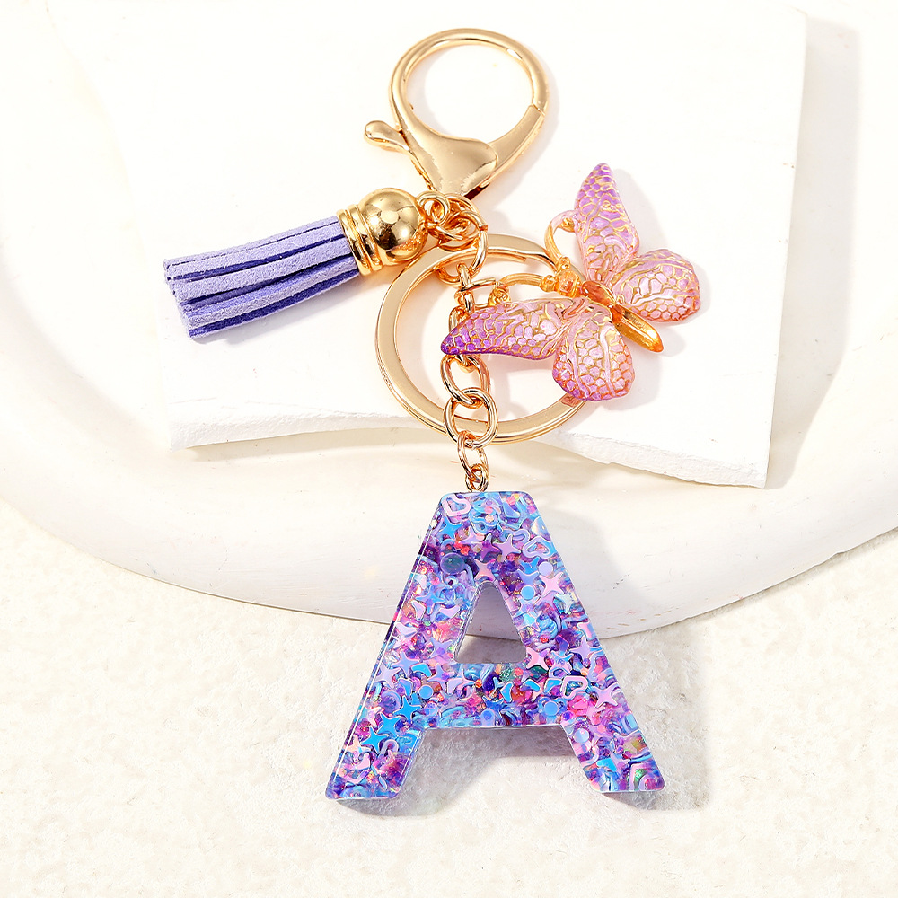 Mayorista transfronterizo mariposa esquinilla iniciales llavero de cristal goteo llavero de letras bolsos colgante
