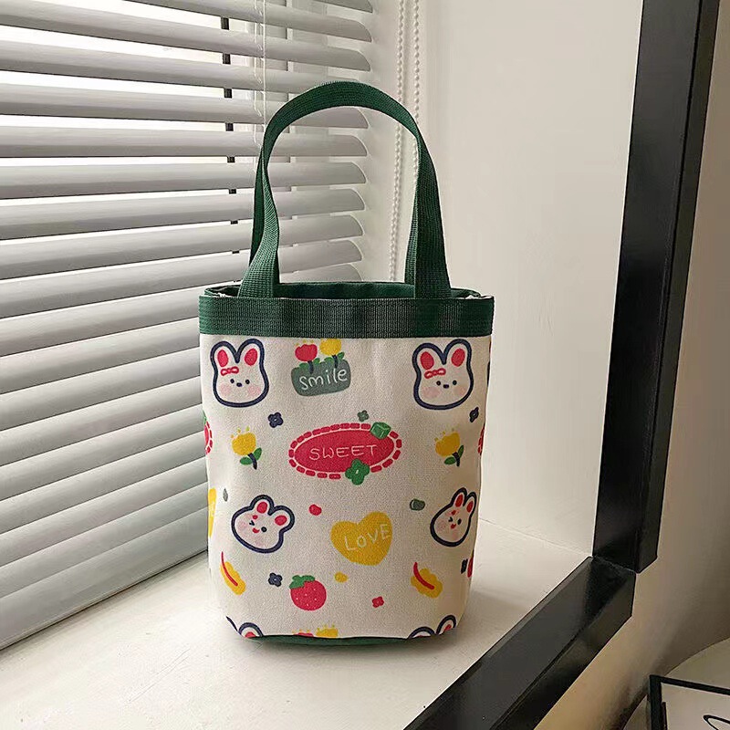 かわいい落書きバケツバッグinsプリント円筒バッグキャンバス弁当袋韓風少女は弁当箱を持っています。|undefined