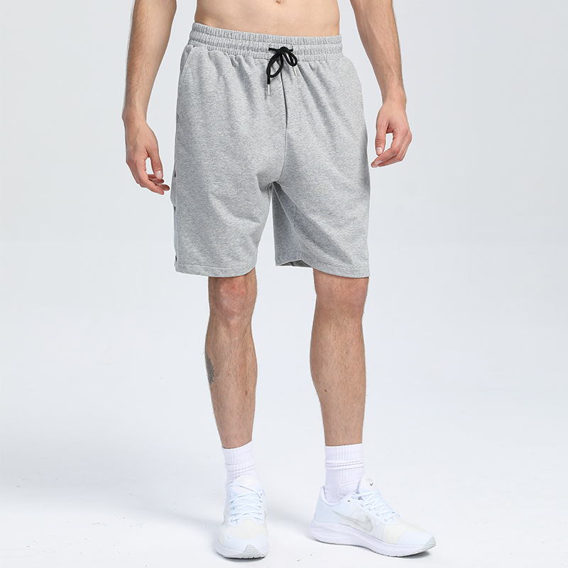 Pantalones cortos deportivos de algodón con botones de color sólido pantalones deportivos de verano transfronterizos de los hombres venta caliente tablero ligero pantalones de fitness que absorben el sudor pantalones de entrenamiento para correr
