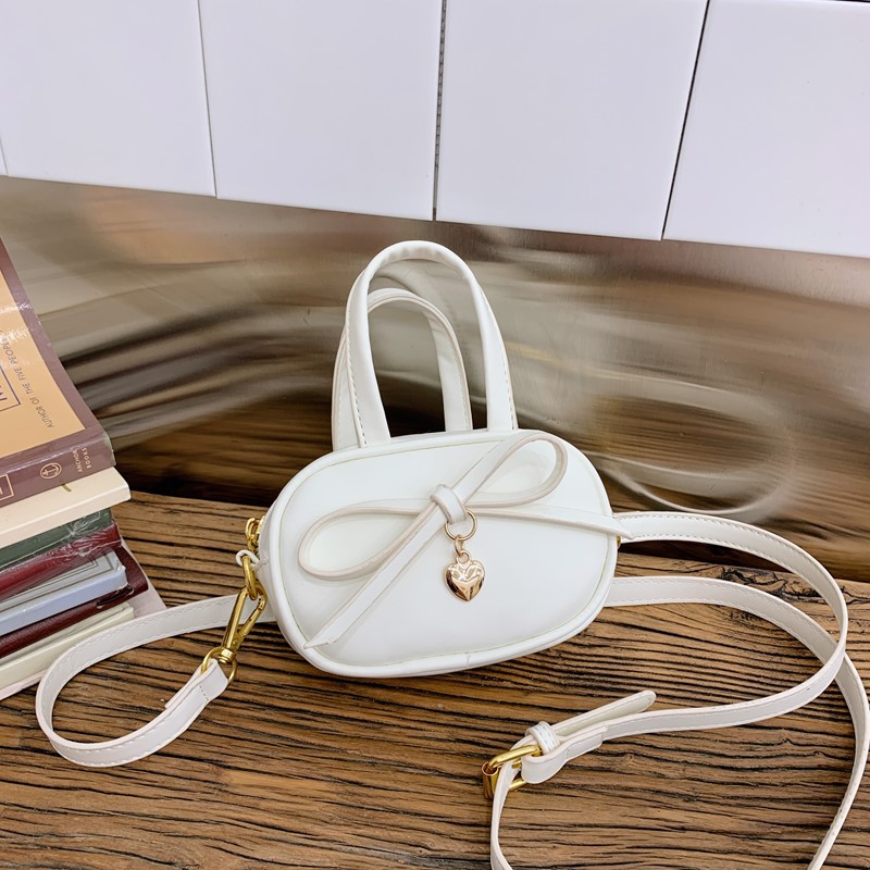 Coreano simple color sólido bolso de hombro para niños y niñas mini bolso de bebé lindo dulce bolso de arco para niños