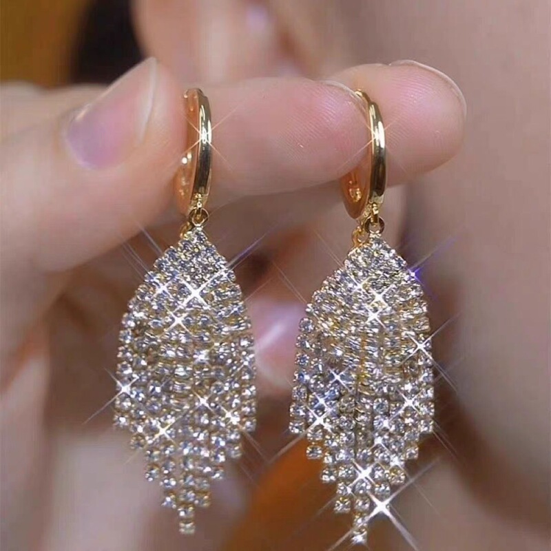 These long, shimmering tassel earrings exude a luxurious and extravagant vibe, offering a touch of high-end elegance and a trendy, Instagram-worthy look These long, shimmering tassel earrings exude a luxurious and extravagant vibe, offering a touch of high-end elegance and a trendy, Instagram-worthy look