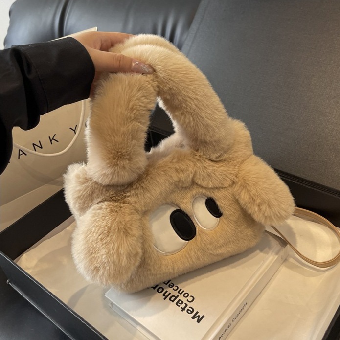 Bolsa de cubo de pelúcia de ojos grandes perros mujeres otoño y invierno 2025 nuevo tipo de bolso de hombro, bolso de mochila encantador