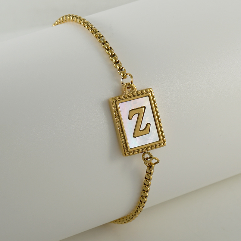 Nuevo europeo y americano transfronterizo de acero inoxidable 26 letras inglesas Shell pulsera personalidad todo partido titanio acero 18K cremallera