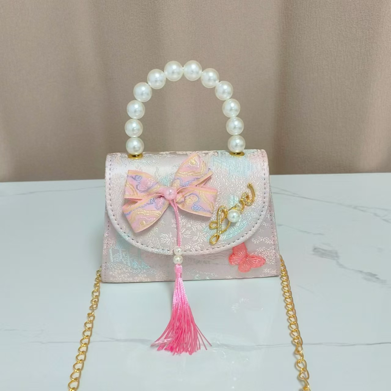 Bolsas de niños arco de estilo chino borda de niña pequeña princesa perla bolsa de cambio de mano al por mayor