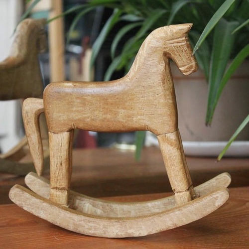 Hand-carved wooden horse from natural wood, pine wood rocking horse with a nostalgic and retro country-style American rural decoration, a rocking horse