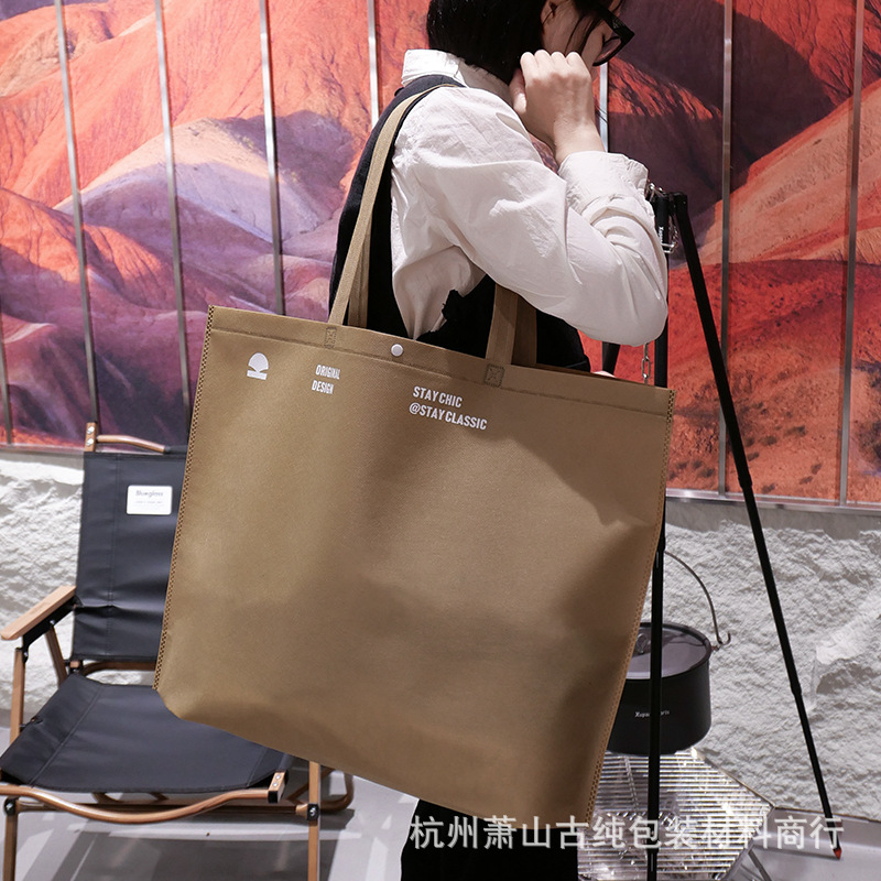 Bolso de mano no tejido de gran capacidad personalizado LOGO engrosado ropa de mujer protección ambiental bolsa de publicidad bolsa de compras de la tienda de ropa