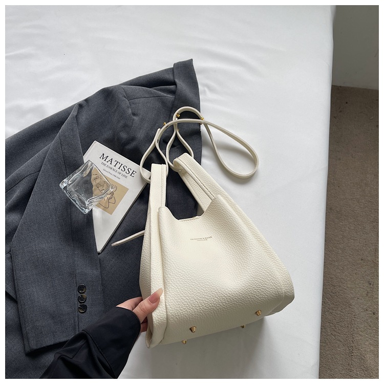 Este año popular simple bolso de cubo portátil para mujeres 2026 nuevo estilo de alto nivel lichi estampado lujoso mochila de hombro
