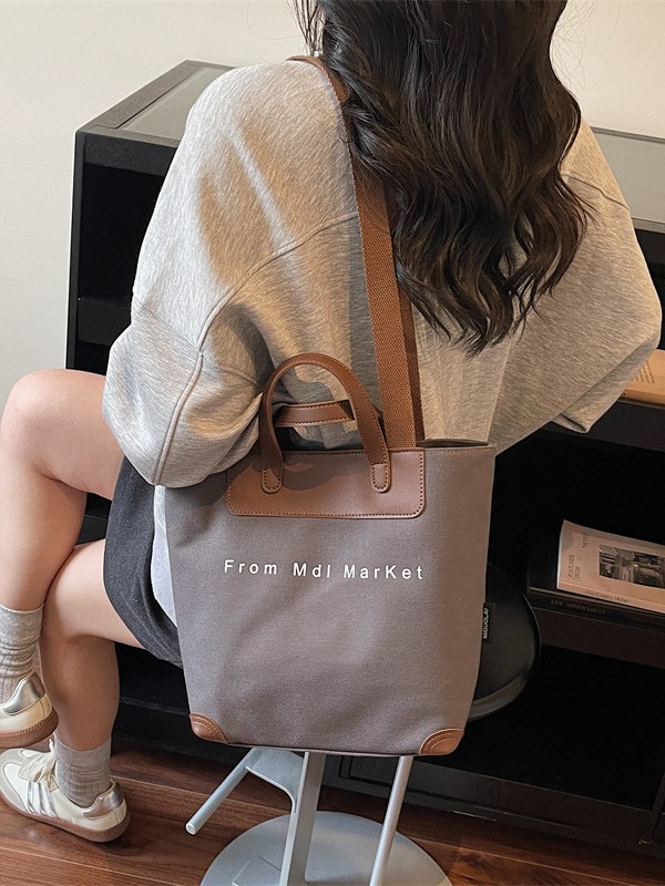 Bolsa de lona coreana hollow-wind casual bolso de mano para mujeres 2026 nueva bolsa de hombro casual simple y lujosa