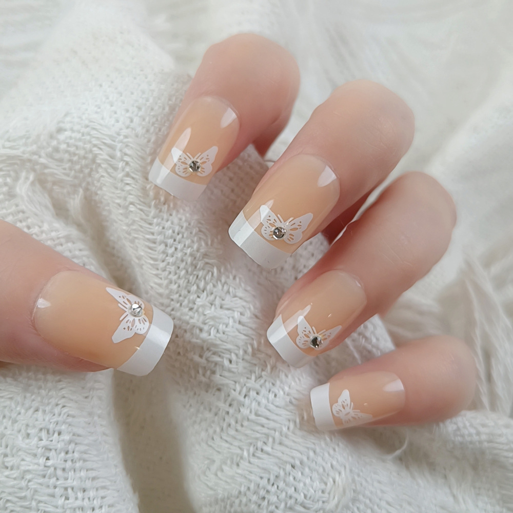 Polvo desnudo punto de perforación mariposa para usar uñas de borde blanco largo estilo francés fresco y elegante 24 piezas de parche de uñas terminadas