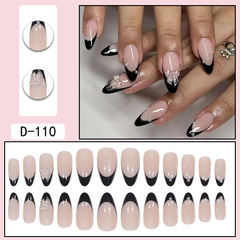 Detachable almond-shaped black French-style nail tips with diamond and butterfly accents—decorative faux nails for stunning manicures