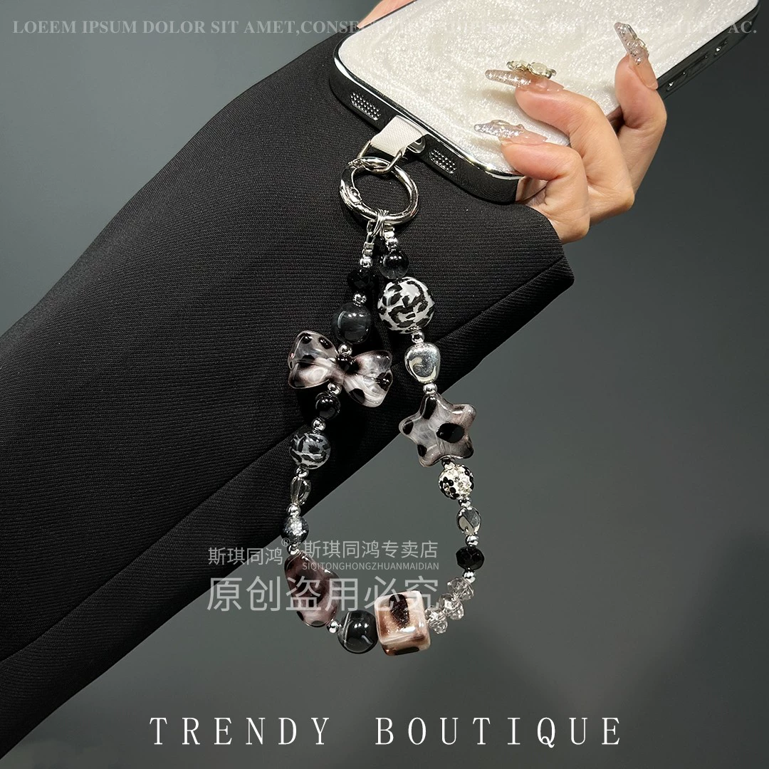 Mobile phone with bow, strap, sophisticated bracelet, pendant