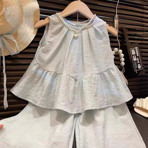 Stylish sleeveless girls' summer set: toddler and small child ruffled blouse with wide-leg pants, trendy two-piece outfit