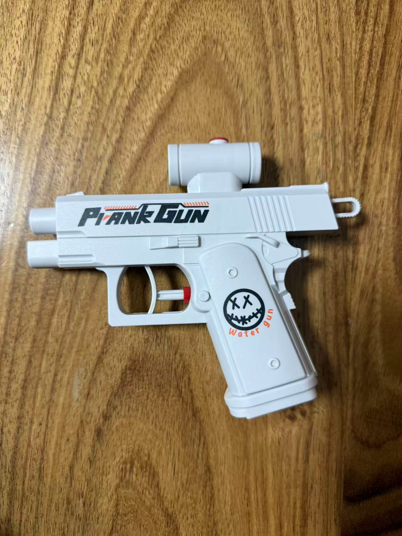 Pequeño libro rojo con la misma pistola de agua de dos caras He Chenguang creativo de la máquina de presión pistola de agua juguete táctica pistola de rociador de agua